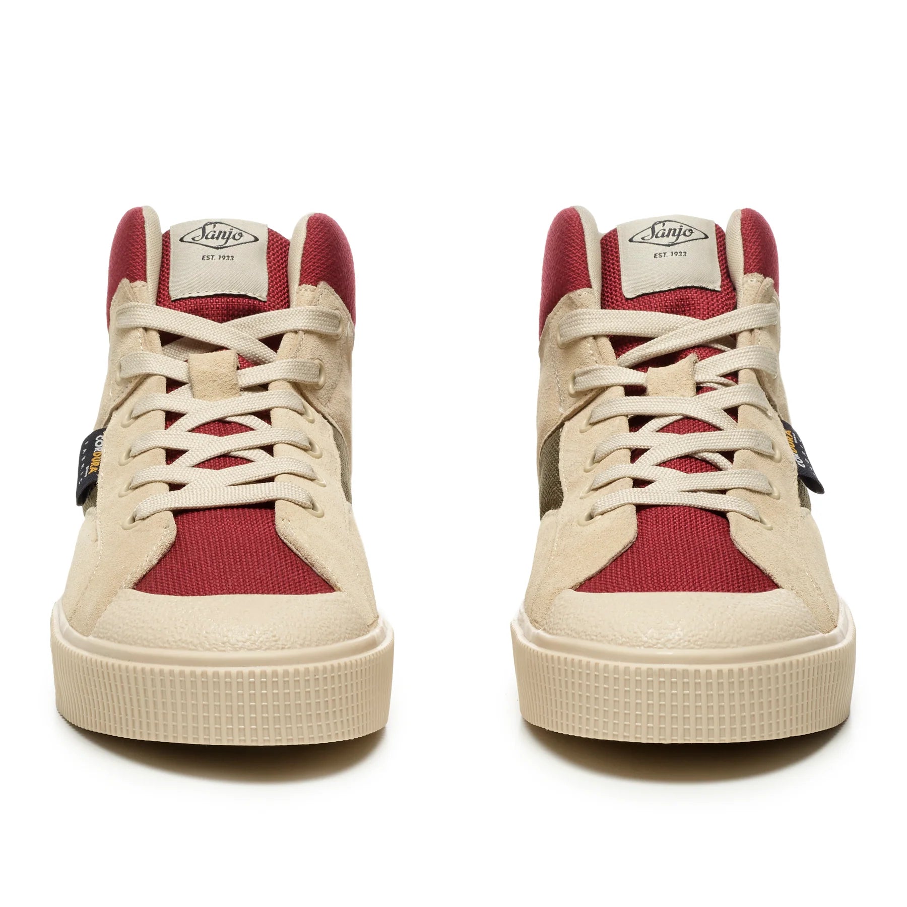 A front view of a Sanjo SK EVO high-top sneakers pair, in a tan, red and green color block design. Features a combination of suede and canvas panels, with a white textured midsole and tonal laces. The ankle area includes a padded, breathable mesh collar for added comfort and support, creating a sleek and versatile look that merges sporty and casual style.