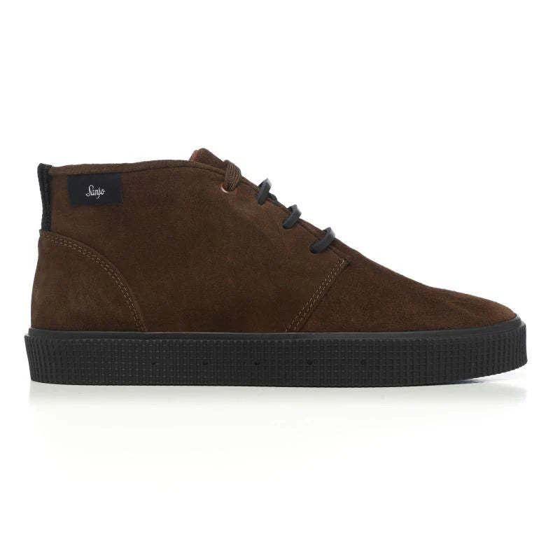 A side view of a Sanjo mid-top suede desert boot in chocolate brown with black laces and a durable black rubber sole, styled with a sleek and versatile design.