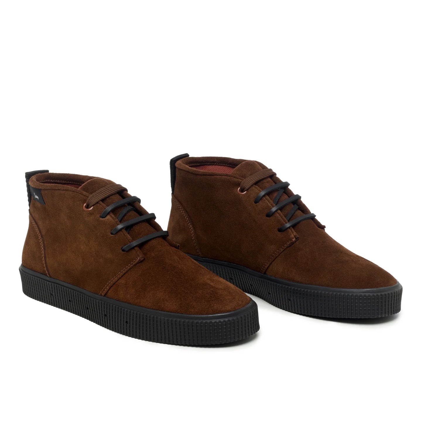 A pair of Sanjo mid-top suede desert boots in chocolate brown with black laces and a durable black rubber sole, styled with a sleek and versatile design.