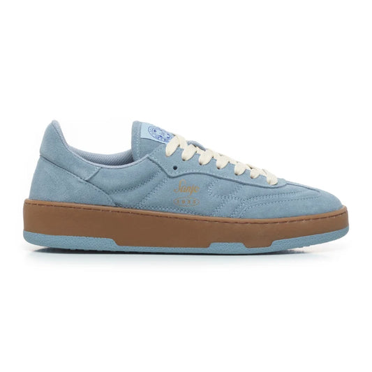 A side view of a Sanjo FTC 86 low-top sneaker in light blue suede with off-white laces, a contrasting gum midsole, and subtle stitching details, inspired by classic football silhouettes.